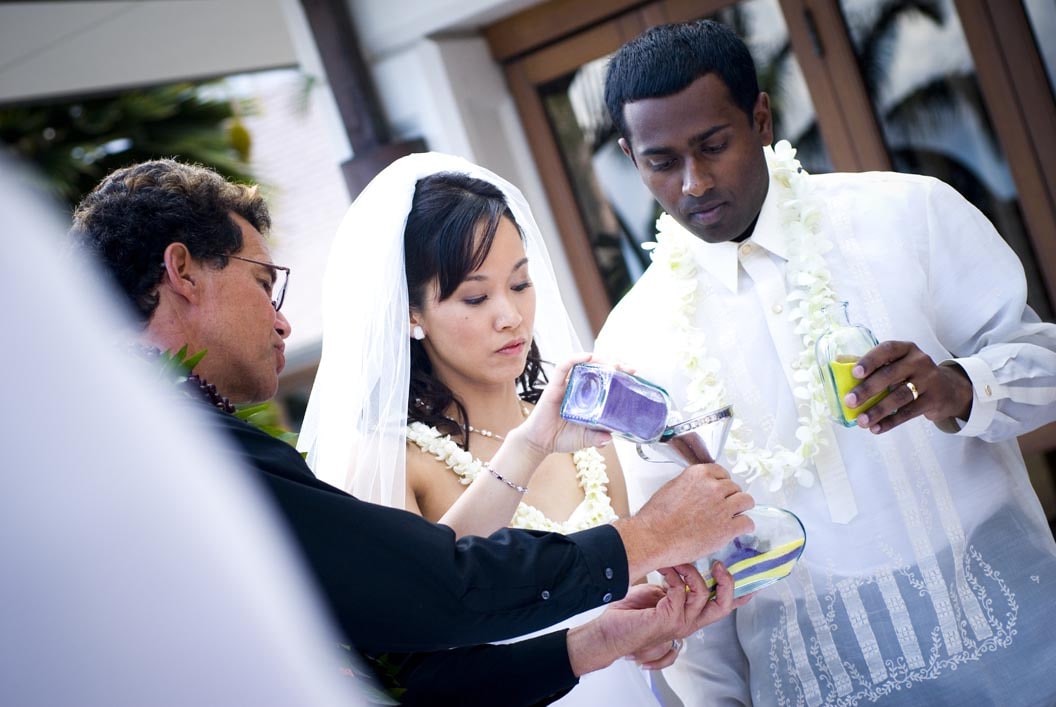 pouring sand at their wedding with rev Kimo